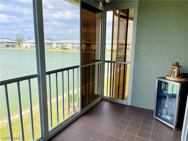 unfurnished sunroom featuring a water view