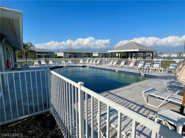 view of swimming pool with a patio and a gazebo