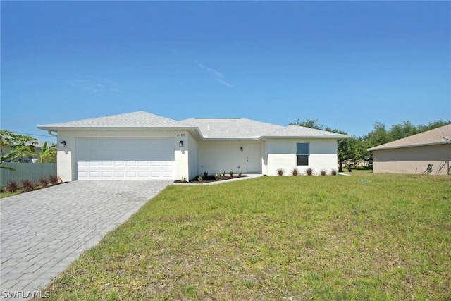 ranch-style home featuring a garage and a front lawn