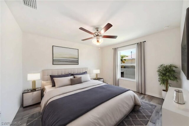 bedroom featuring dark hardwood / wood-style flooring and ceiling fan