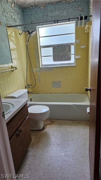 full bathroom featuring vanity, toilet, and tiled shower / bath combo