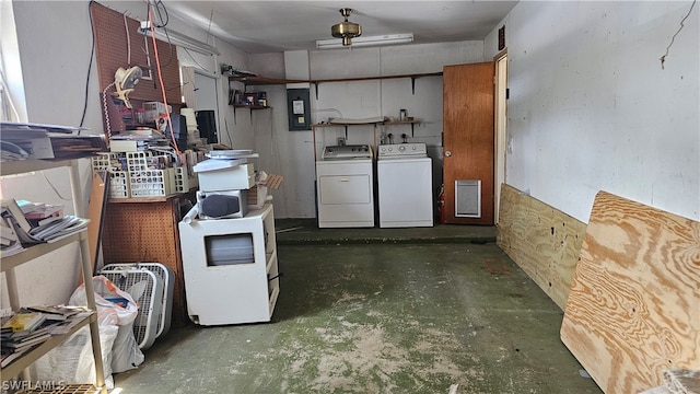 kitchen featuring concrete floors and washing machine and dryer