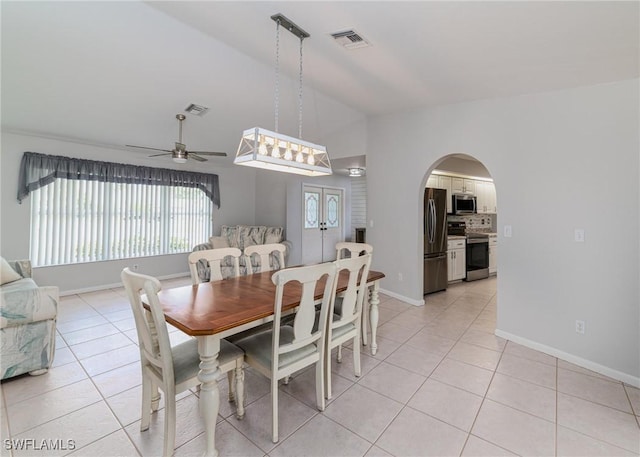 2201 SE 10th Ave, Cape Coral, FL 33990 - dining space featuring vaulted ceiling, ceiling fan, plenty of natural light, light tile patterned flooring, and arched walkways
