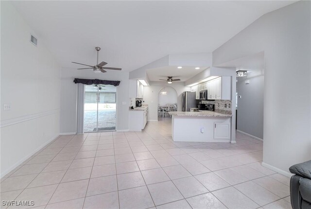 kitchen featuring kitchen peninsula, white cabinets, backsplash, ceiling fan, and stainless steel appliances