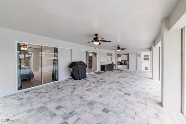 view of patio featuring ceiling fan