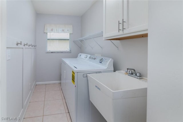 2201 SE 10th Ave, Cape Coral, FL 33990 - washroom featuring cabinet space, separate washer and dryer, light tile patterned flooring, and baseboards