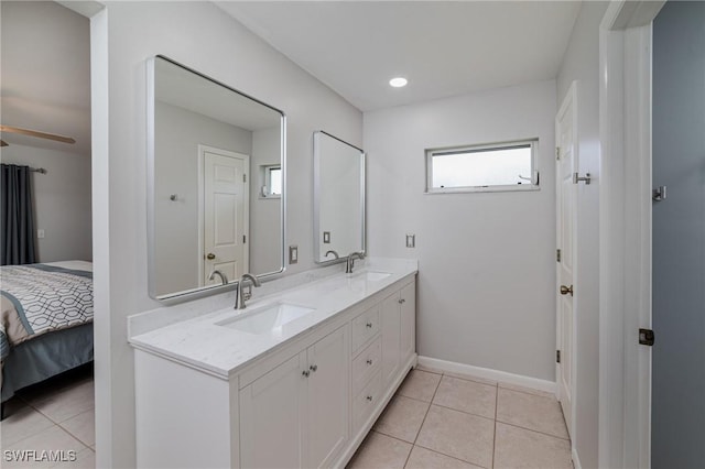 2201 SE 10th Ave, Cape Coral, FL 33990 - ensuite bathroom featuring double vanity, tile patterned floors, baseboards, recessed lighting, and ceiling fan