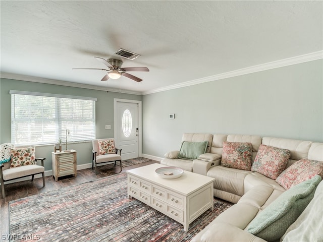 living room featuring crown molding, visible vents, a ceiling fan, wood finished floors, and baseboards