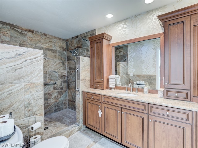 bathroom featuring recessed lighting, toilet, a stall shower, vanity, and wallpapered walls