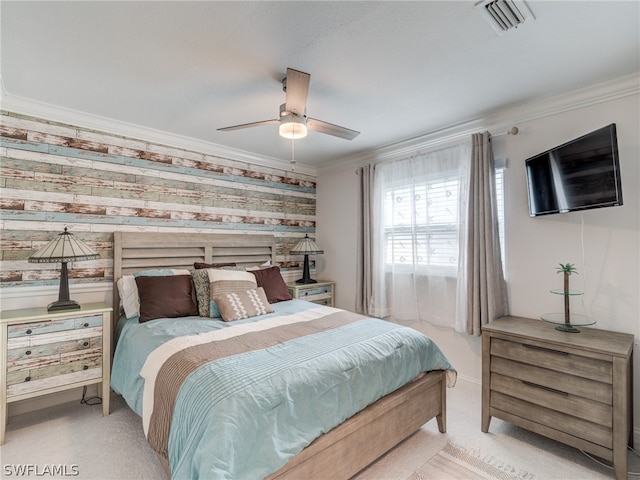 carpeted bedroom featuring visible vents, ornamental molding, a ceiling fan, baseboards, and wallpapered walls