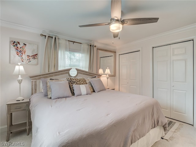 bedroom with ceiling fan, two closets, and crown molding