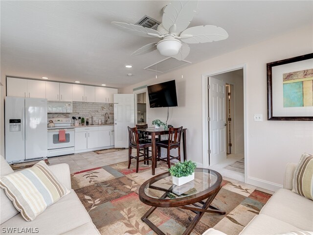 living area featuring recessed lighting, visible vents, a ceiling fan, baseboards, and attic access