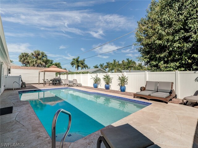 view of swimming pool with a patio area, a fenced backyard, and a gazebo