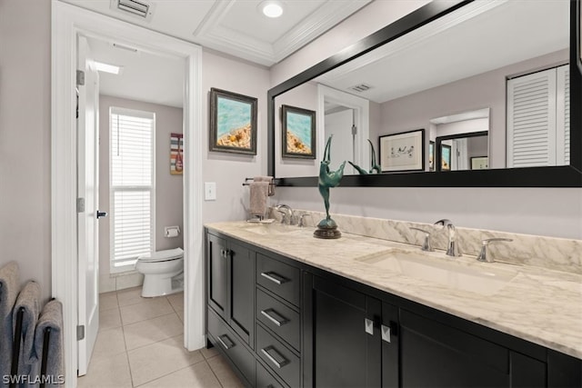 bathroom with a wealth of natural light, toilet, tile flooring, and double sink vanity