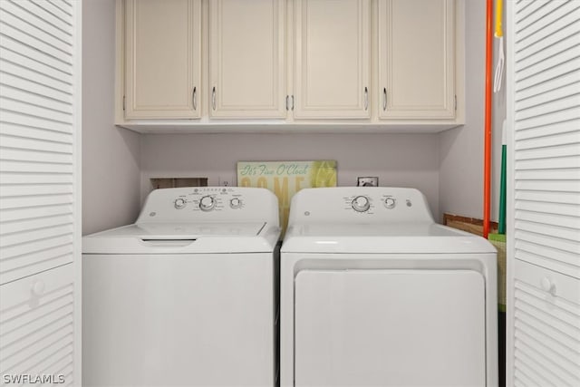 laundry area featuring cabinets, washing machine and dryer, and washer hookup