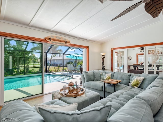 living room featuring light hardwood / wood-style flooring, ceiling fan, and lofted ceiling