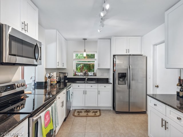 kitchen featuring sink, appliances with stainless steel finishes, and white cabinetry