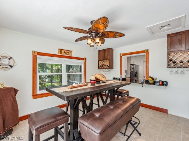 tiled dining room with ceiling fan