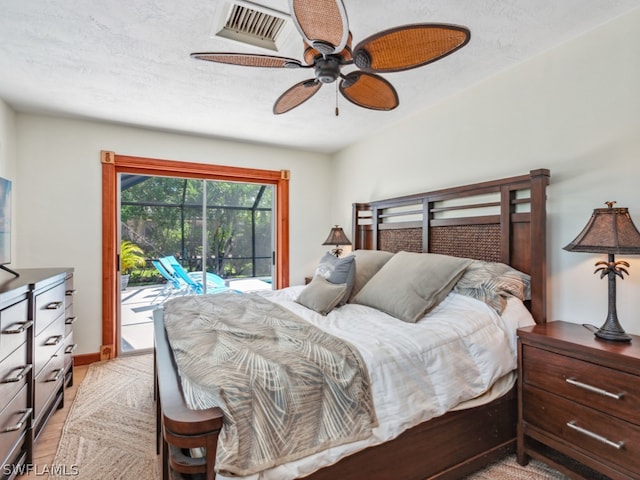 bedroom featuring light hardwood / wood-style flooring, a textured ceiling, ceiling fan, and access to exterior