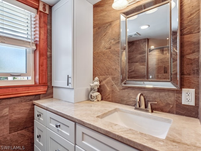 bathroom with tile walls and vanity