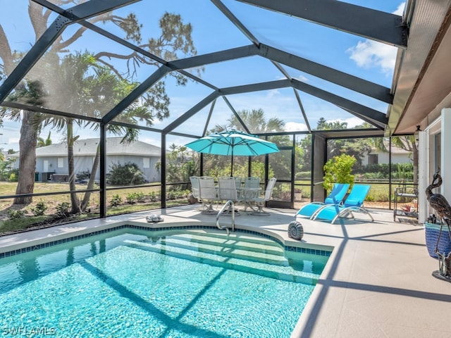 view of swimming pool featuring a lanai and a patio area