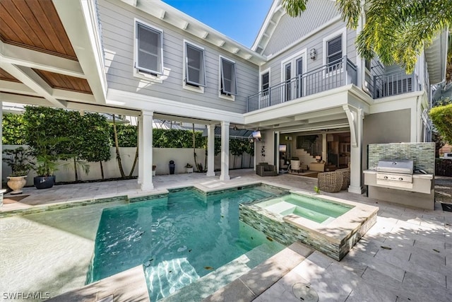 view of swimming pool featuring a patio, a grill, area for grilling, and an in ground hot tub