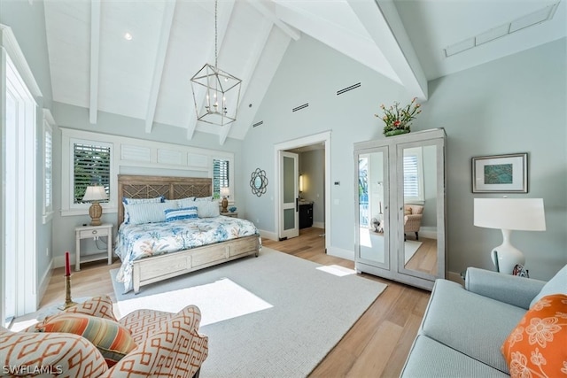 bedroom featuring light hardwood / wood-style floors, a chandelier, and multiple windows