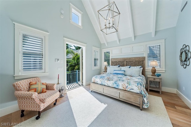 bedroom featuring high vaulted ceiling, access to outside, beam ceiling, a notable chandelier, and light hardwood / wood-style floors