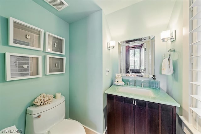 bathroom with toilet and oversized vanity