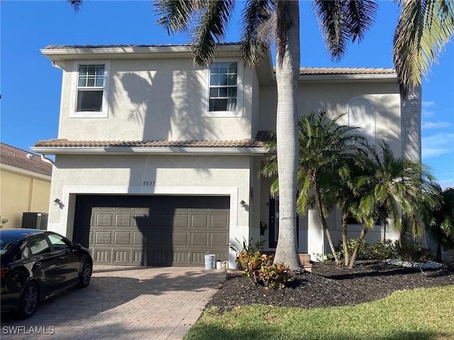 mediterranean / spanish-style house with a garage