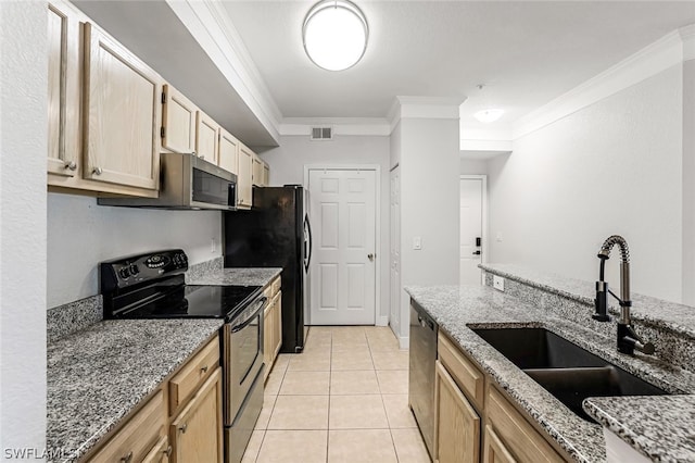 kitchen with light stone countertops, light tile flooring, crown molding, appliances with stainless steel finishes, and sink