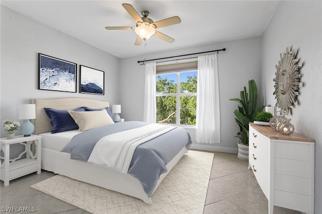 bedroom featuring ceiling fan and light tile floors