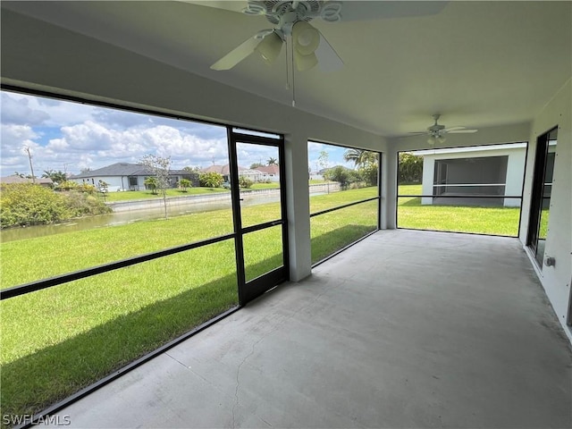 unfurnished sunroom featuring ceiling fan