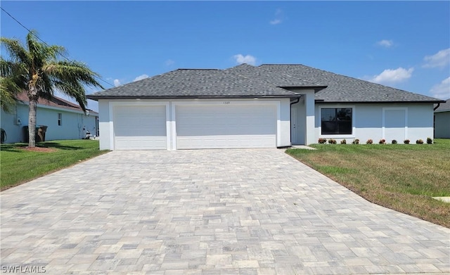 view of front of property with a garage and a front lawn