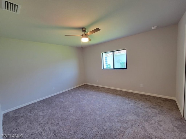 carpeted spare room featuring ceiling fan