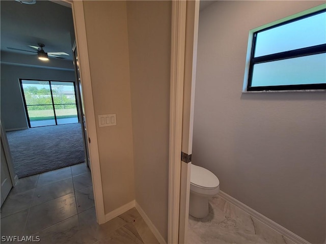 bathroom featuring ceiling fan and toilet