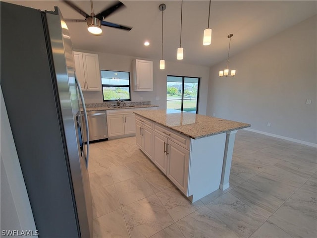 kitchen featuring appliances with stainless steel finishes, a center island, white cabinetry, and sink