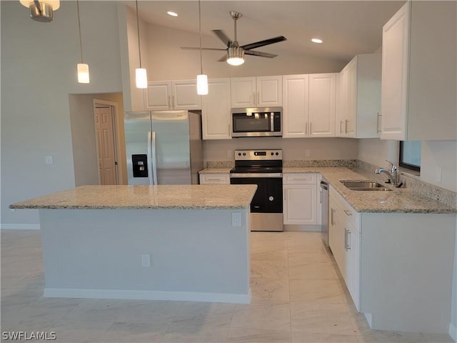 kitchen featuring white cabinetry, sink, a center island, pendant lighting, and appliances with stainless steel finishes