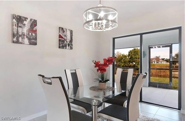 tiled dining area featuring an inviting chandelier