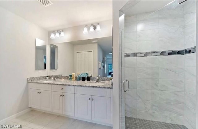 bathroom featuring tile patterned floors, vanity, and walk in shower