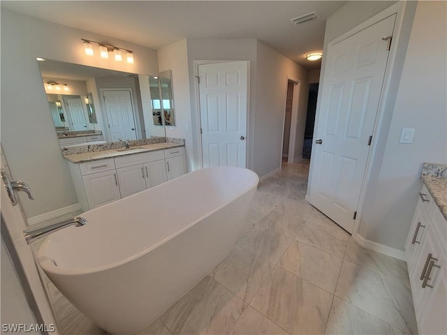 bathroom featuring vanity and a tub