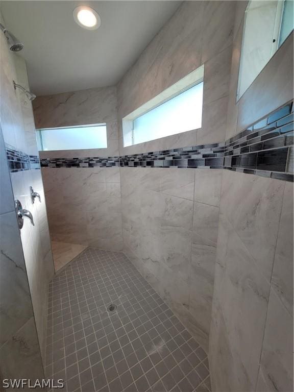 bathroom with tiled shower