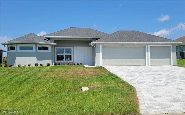 view of front of property with a garage and a front lawn