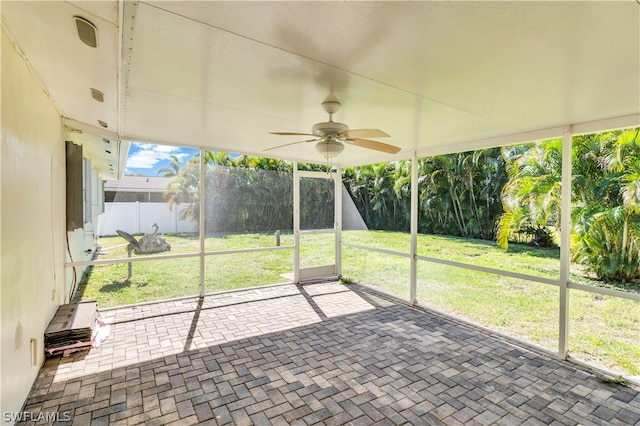 unfurnished sunroom with ceiling fan