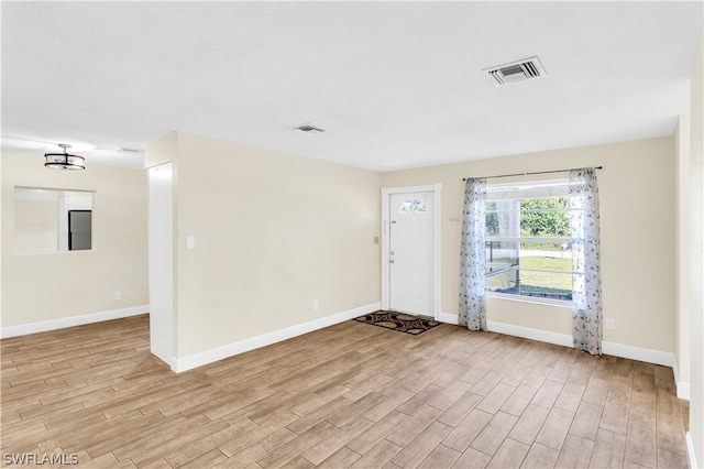 empty room with light hardwood / wood-style flooring