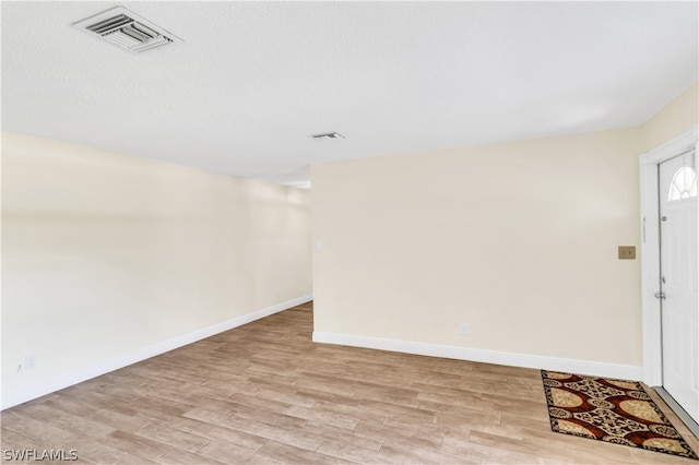 spare room featuring light hardwood / wood-style floors