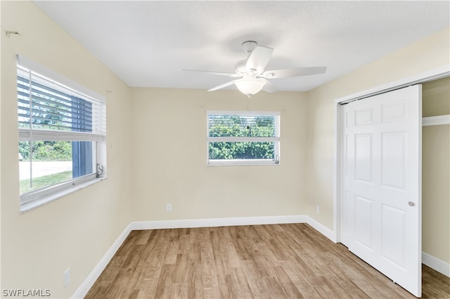 unfurnished bedroom with a closet, ceiling fan, and light wood-type flooring