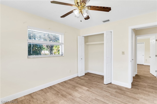 unfurnished bedroom featuring a closet, light hardwood / wood-style floors, and ceiling fan