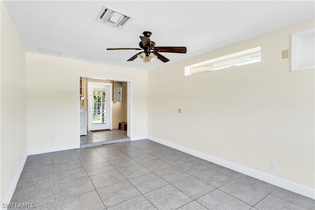 tiled empty room featuring ceiling fan