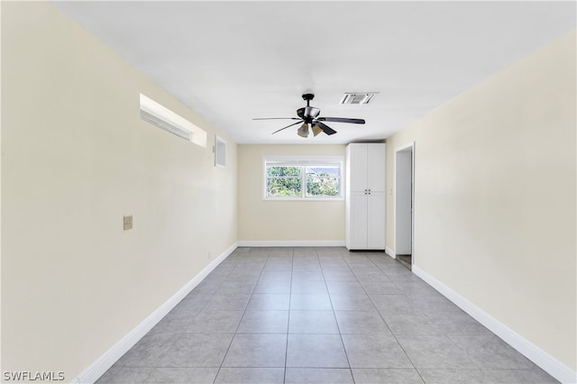 unfurnished room featuring ceiling fan and light tile flooring